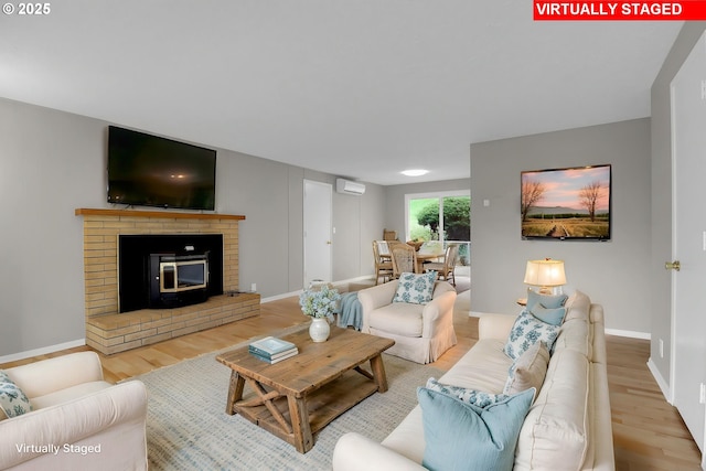 29652 Lusk Rd, Eugene, OR 97405 - living room featuring wood finished floors, a wall mounted AC, and baseboards