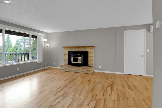 29652 Lusk Rd, Eugene, OR 97405 - unfurnished living room with wood finished floors, baseboards, and a textured ceiling