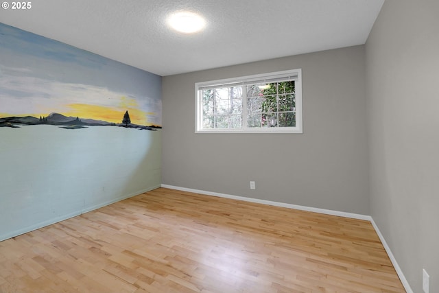 29652 Lusk Rd, Eugene, OR 97405 - empty room featuring wood finished floors, baseboards, and a textured ceiling