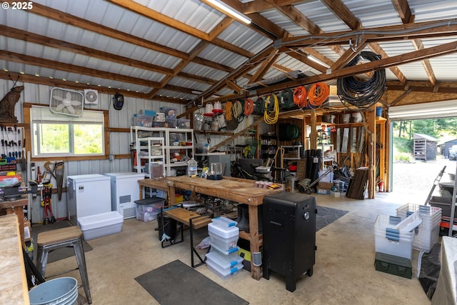 garage with a workshop area and fridge