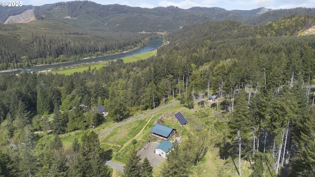 bird's eye view with a wooded view and a water and mountain view