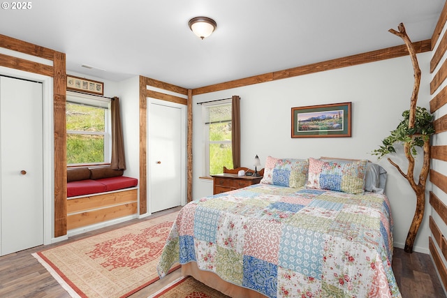 bedroom with baseboards and wood finished floors