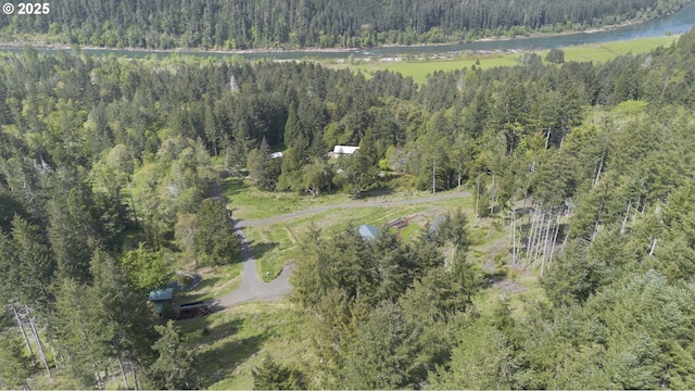 aerial view featuring a water view and a forest view