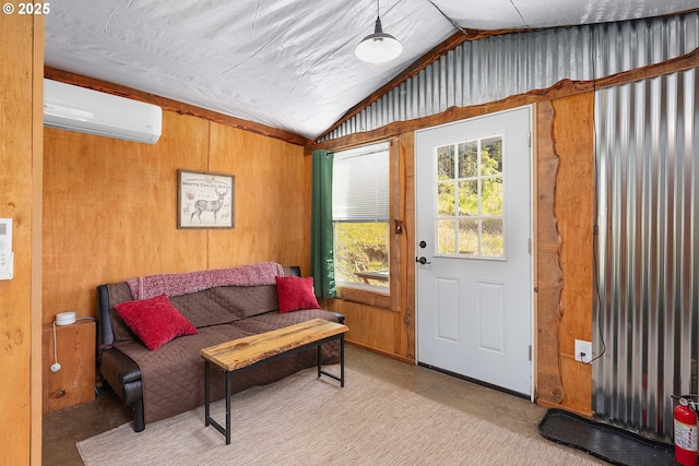 sitting room with an AC wall unit, wood walls, and lofted ceiling