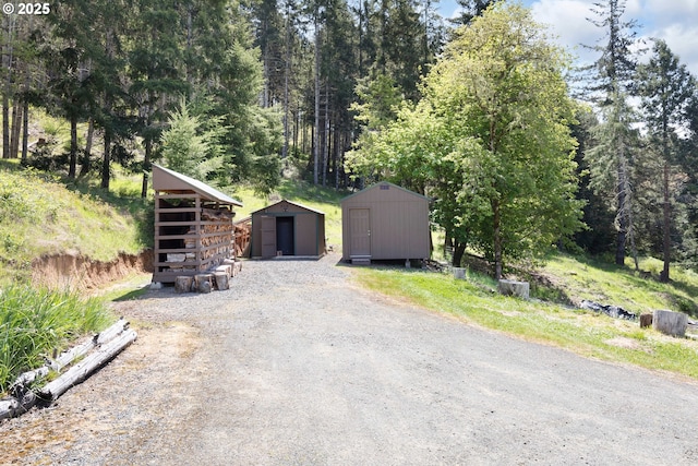 view of front of home with an outdoor structure and a shed