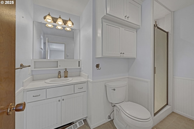 85304 Nestle Way, Pleasant Hill, OR 97455 - full bathroom featuring a wainscoted wall, a stall shower, toilet, and vanity