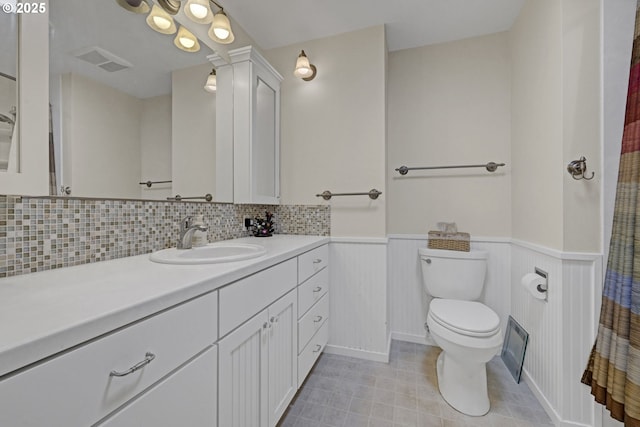 85304 Nestle Way, Pleasant Hill, OR 97455 - full bath with toilet, wainscoting, vanity, tile patterned flooring, and decorative backsplash