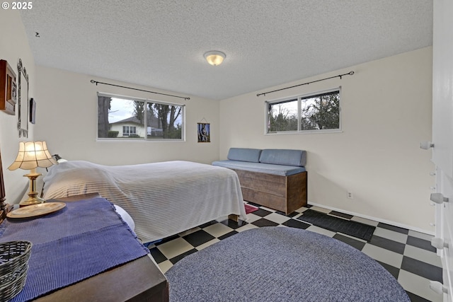 85304 Nestle Way, Pleasant Hill, OR 97455 - bedroom featuring tile patterned floors, a textured ceiling, and baseboards