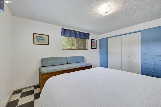 85304 Nestle Way, Pleasant Hill, OR 97455 - bedroom with tile patterned floors, a textured ceiling, and a closet