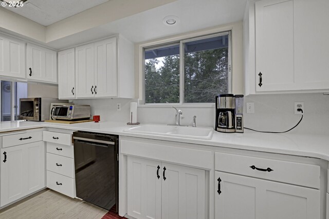 85304 Nestle Way, Pleasant Hill, OR 97455 - kitchen with dishwasher, a sink, white cabinetry, and light countertops