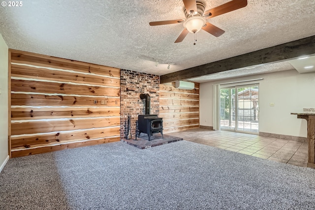 16127 NE Caples Rd, Brush Prairie, WA 98606 - unfurnished living room with a textured ceiling, a wood stove, a wall mounted AC, wood walls, and tile patterned floors