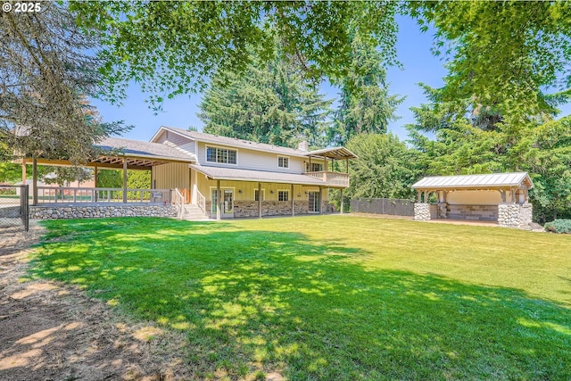 16127 NE Caples Rd, Brush Prairie, WA 98606 - rear view of house with stone siding, a chimney, and a wooden deck