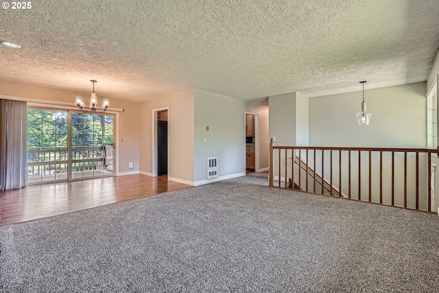 16127 NE Caples Rd, Brush Prairie, WA 98606 - carpeted empty room featuring a chandelier, a textured ceiling, and heating unit