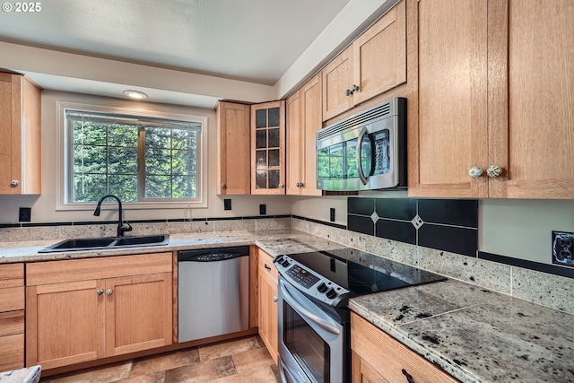 16127 NE Caples Rd, Brush Prairie, WA 98606 - kitchen featuring stainless steel appliances, glass insert cabinets, stone finish floors, and light brown cabinetry