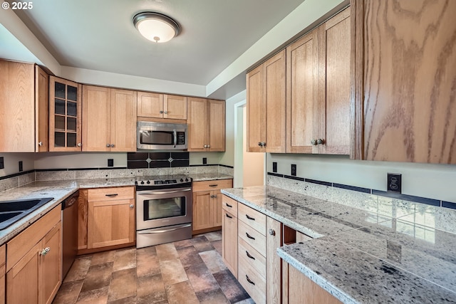 16127 NE Caples Rd, Brush Prairie, WA 98606 - kitchen with stainless steel appliances, glass insert cabinets, stone finish flooring, light stone countertops, and light brown cabinetry