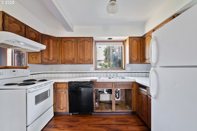 520 Elm Ave, Tillamook, OR 97141 - kitchen featuring white appliances, a sink, under cabinet range hood, brown cabinets, and dark wood-type flooring