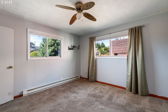 520 Elm Ave, Tillamook, OR 97141 - unfurnished room with baseboard heating, healthy amount of natural light, carpet, ceiling fan, and a textured ceiling