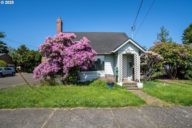 520 Elm Ave, Tillamook, OR 97141 - view of front of house featuring a chimney, roof with shingles, and a front lawn