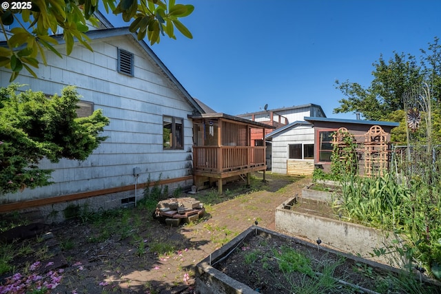 520 Elm Ave, Tillamook, OR 97141 - view of yard featuring a garden, a deck, and an outbuilding