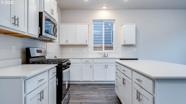 247 Stella St, Salem, OR 97301 - kitchen featuring appliances with stainless steel finishes, recessed lighting, light countertops, white cabinets, and dark wood finished floors