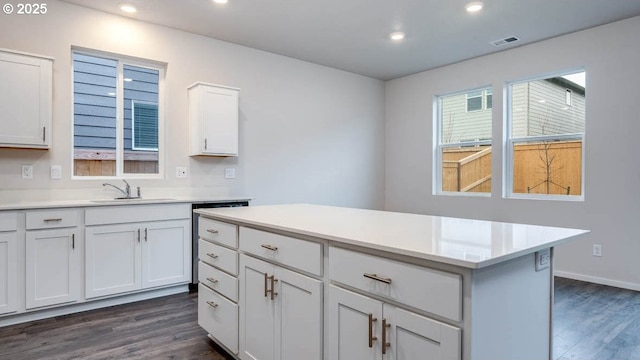 247 Stella St, Salem, OR 97301 - kitchen with dark wood finished floors, white cabinetry, recessed lighting, light countertops, and a center island
