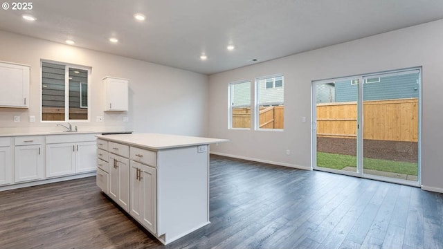 247 Stella St, Salem, OR 97301 - kitchen with dark wood finished floors, light countertops, white cabinetry, recessed lighting, and a kitchen island