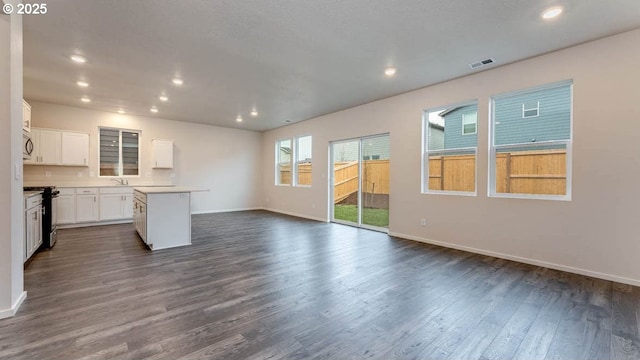 247 Stella St, Salem, OR 97301 - unfurnished living room featuring dark wood-style flooring and recessed lighting