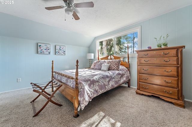 carpeted bedroom featuring ceiling fan, a textured ceiling, and lofted ceiling