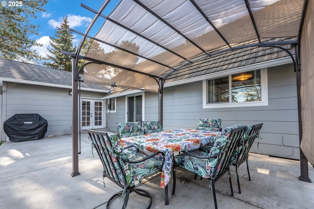 view of patio / terrace featuring a lanai, outdoor dining space, and french doors