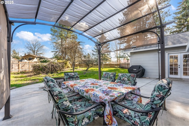 view of patio with area for grilling, a pergola, a fenced backyard, french doors, and outdoor dining area