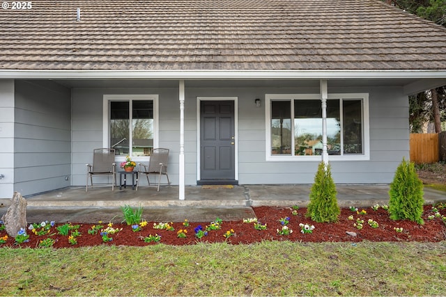 view of exterior entry with covered porch