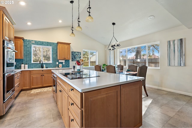 kitchen featuring tasteful backsplash, a center island, light countertops, black electric stovetop, and vaulted ceiling