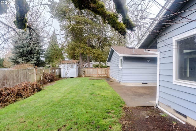 view of yard featuring a patio area, a fenced backyard, a shed, and an outbuilding