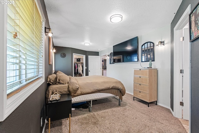 1701 Walnut St, La Grande, OR 97850 - carpeted bedroom with a textured ceiling, baseboards, a spacious closet, and a closet