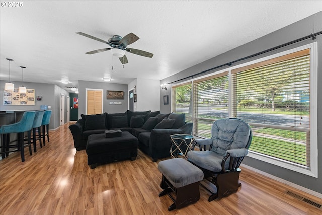 1701 Walnut St, La Grande, OR 97850 - living room with wood finished floors, ceiling fan, a textured ceiling, and baseboards