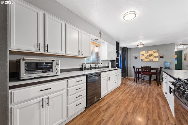 1701 Walnut St, La Grande, OR 97850 - kitchen featuring black appliances, a sink, white cabinetry, and light wood-style floors