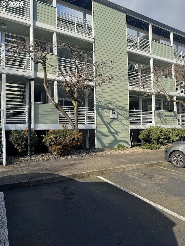 view of building exterior featuring uncovered parking