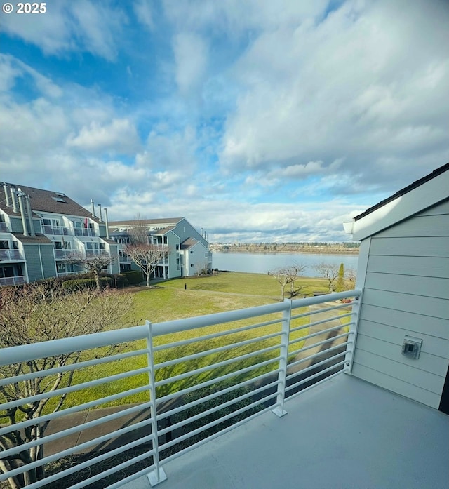 balcony featuring a residential view and a water view