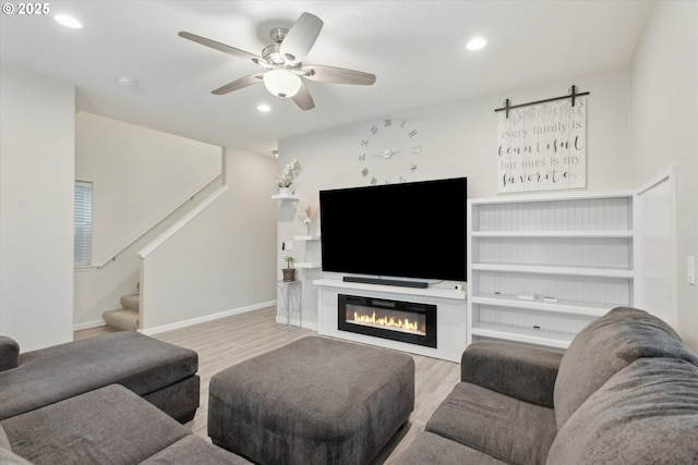 living room featuring recessed lighting, wood finished floors, stairs, and ceiling fan