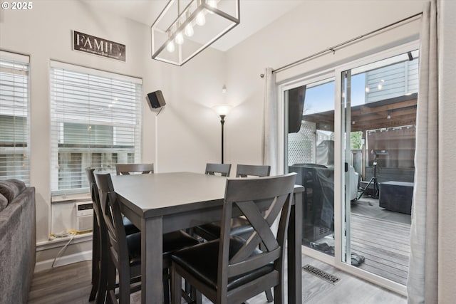 dining area featuring visible vents and wood finished floors