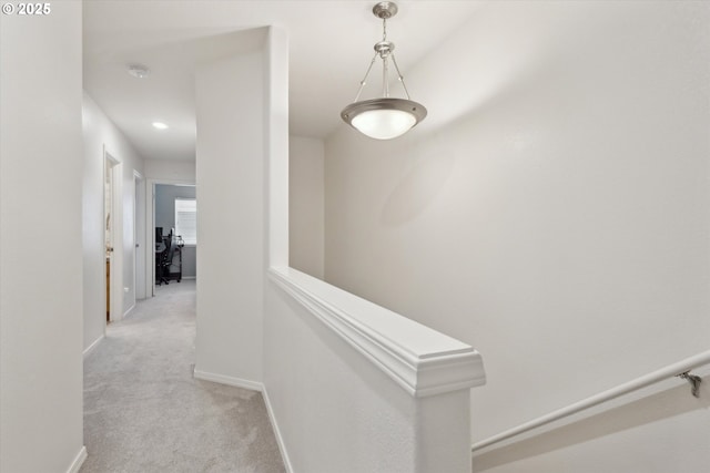 hall with light carpet and baseboards