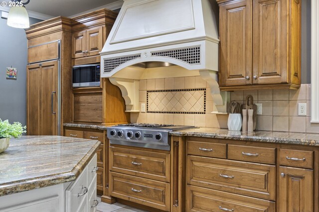 24800 SW Big Fir Rd, West Linn, OR 97068 - kitchen featuring custom range hood, built in appliances, brown cabinetry, backsplash, and light stone countertops