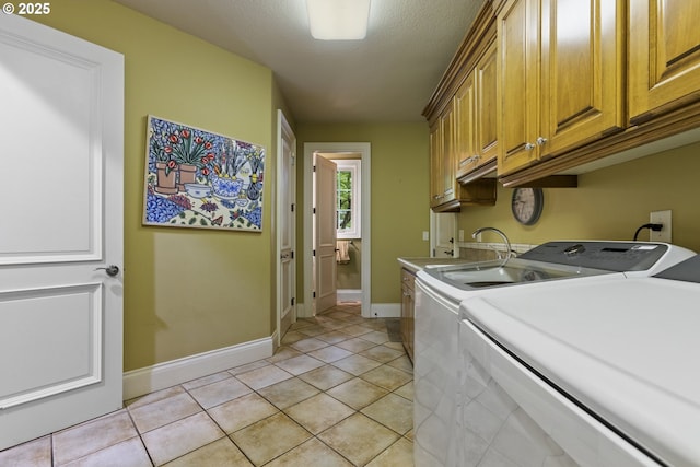 24800 SW Big Fir Rd, West Linn, OR 97068 - laundry room featuring washer and dryer, cabinet space, baseboards, and light tile patterned floors