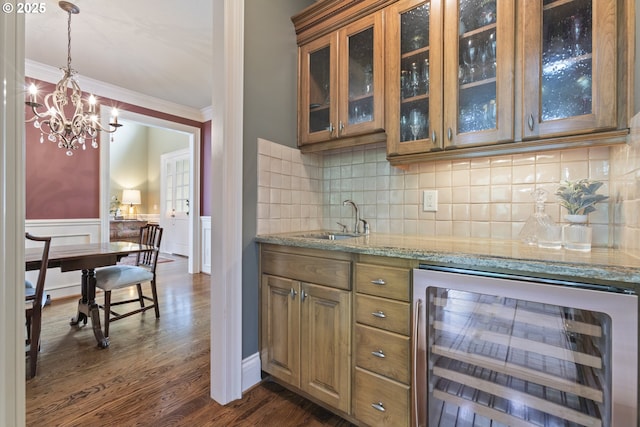 24800 SW Big Fir Rd, West Linn, OR 97068 - indoor bar with wine cooler, ornamental molding, dark wood-type flooring, a chandelier, and decorative backsplash