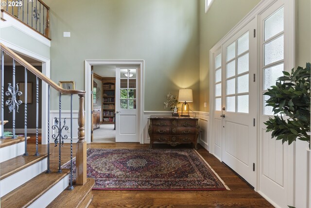 24800 SW Big Fir Rd, West Linn, OR 97068 - foyer entrance with a towering ceiling, wainscoting, wood finished floors, and stairway