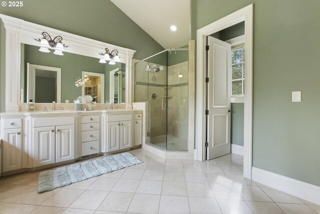 24800 SW Big Fir Rd, West Linn, OR 97068 - bathroom featuring double vanity, a stall shower, vaulted ceiling, tile patterned floors, and baseboards