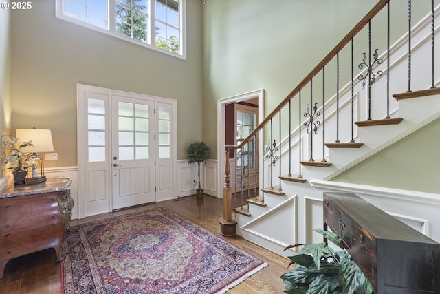 24800 SW Big Fir Rd, West Linn, OR 97068 - foyer entrance featuring a high ceiling, a wainscoted wall, stairway, and wood finished floors