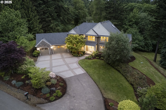 24800 SW Big Fir Rd, West Linn, OR 97068 - traditional-style home featuring concrete driveway, an attached garage, stone siding, a forest view, and a front yard
