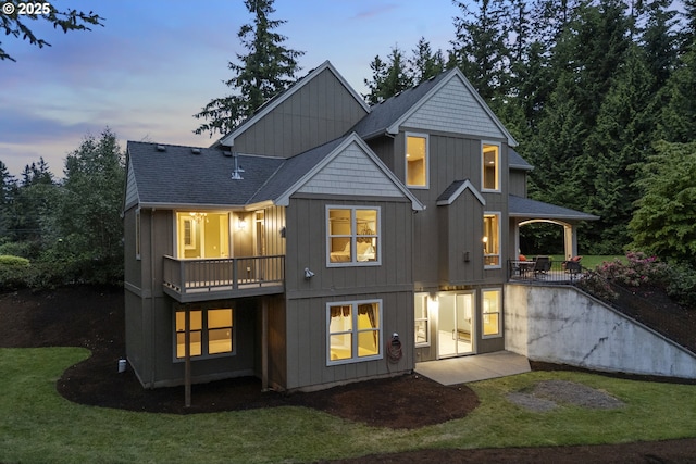 24800 SW Big Fir Rd, West Linn, OR 97068 - back of property at dusk with a yard, a patio area, and board and batten siding