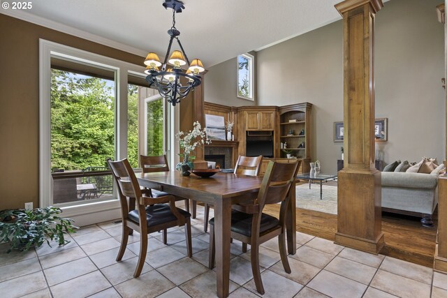 24800 SW Big Fir Rd, West Linn, OR 97068 - dining area with ornate columns, crown molding, a chandelier, and healthy amount of natural light